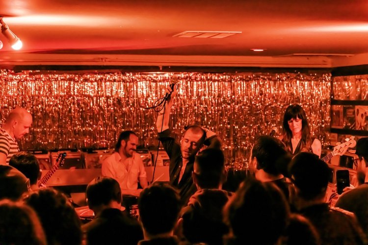 Band performing on a stage in front of a crowd of people