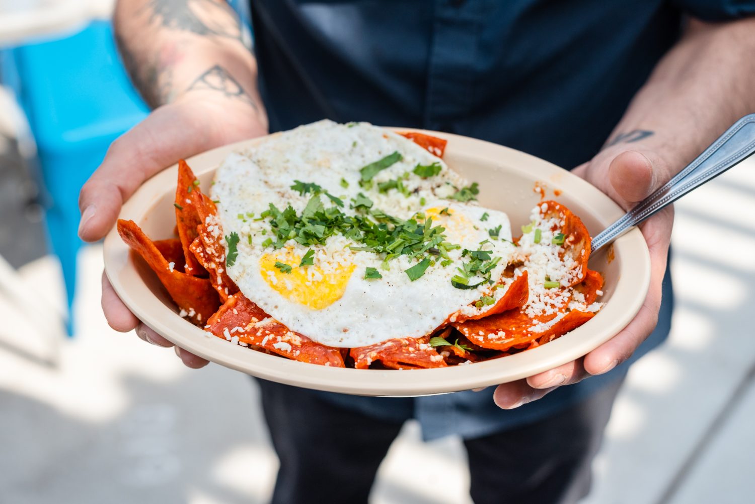 orange nachos with fried egg, cheese, and garnish