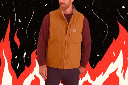 A model wearing a Carhartt vest, on a vintage flame background.