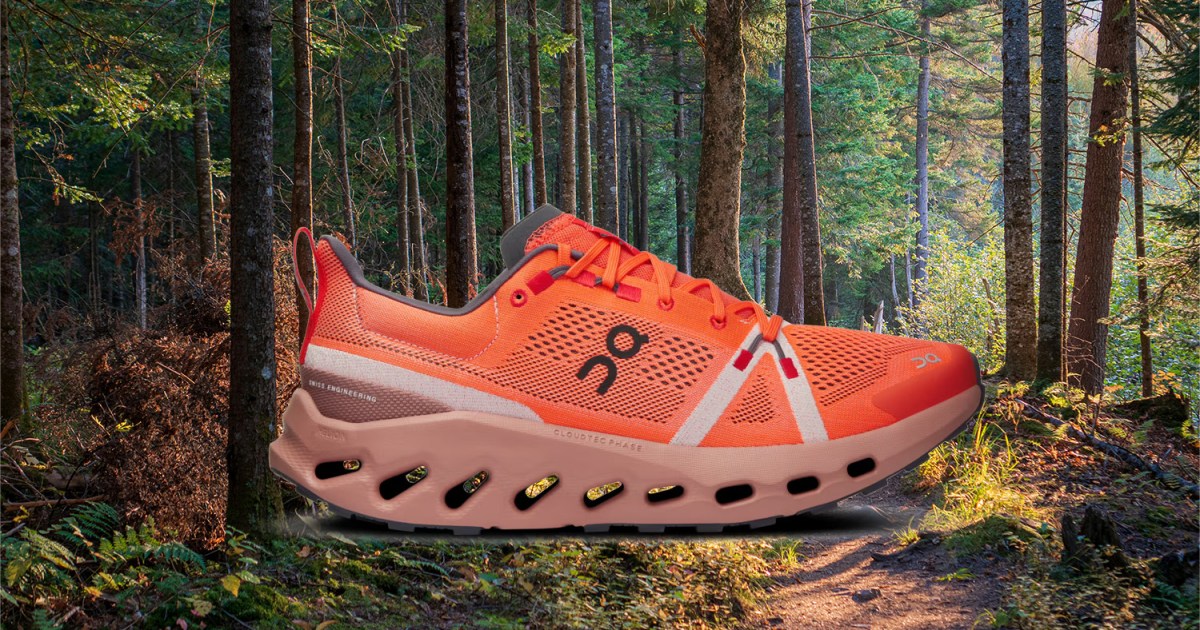 The On Cloudsurfer Trail, a trail-running shoe, against a forest background. Here's our full review of the shoes.