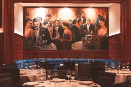 A large painting above at booth at Delmonico's, one of the oldest restaurants in NYC