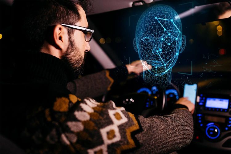 A man driving a car while his face gets scanned by facial recognition technology