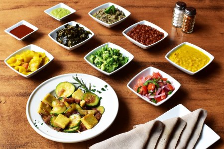 Spread of food in bowls on a table from Letena