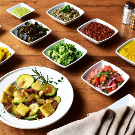 Spread of food in bowls on a table from Letena