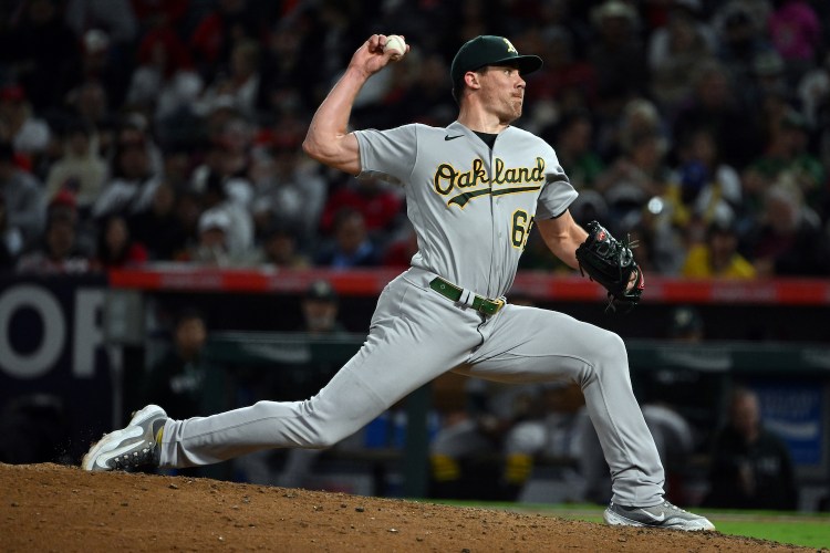 Oakland Athletics pitcher Trevor May (65) pitching during an MLB baseball game