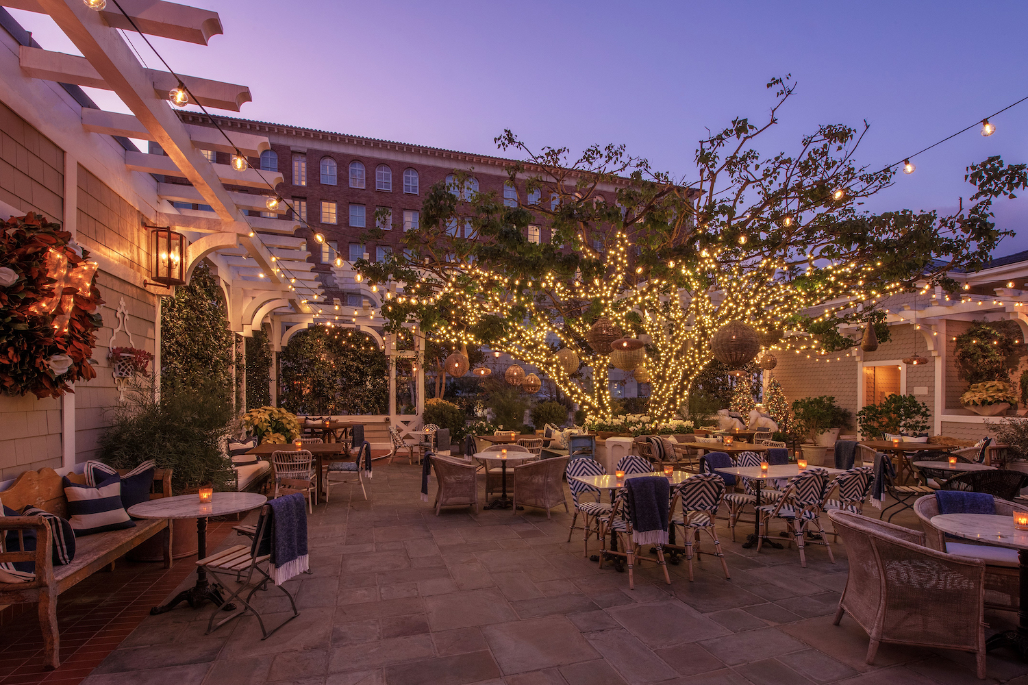 outdoors, chairs and tables, fairy lights on trees. sunset sky