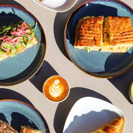 sandwich, avocado toast, matcha latte, coffee latte, blue plates