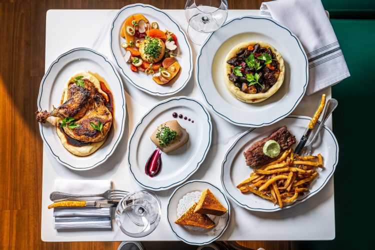 different plates of food on dining table