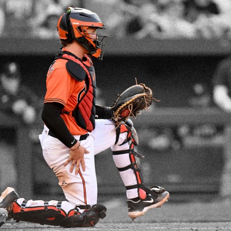 A catcher for the Baltimore Orioles stretches his leg out to one side. Here's what we can learn from the mobility routines of MLB catchers.