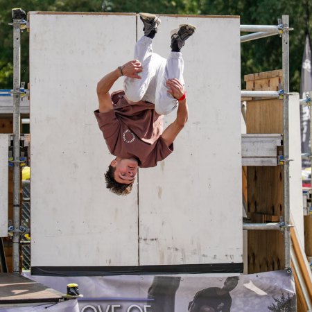 A parkour competitor captured mid-backflip.