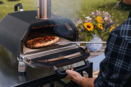 A pizza going into the Ooni Karu 16 Multi-Fuel Pizza Oven, now on sale for Black Friday