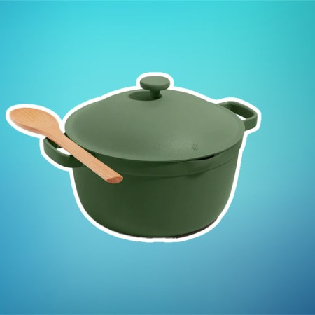 An Our Place Perfect Pot in green on a teal and blue background