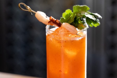 Close-up of orange-colored cocktail with garnishes