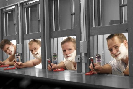 A line of men testing out wet-shave razors at separate stations. We're looking at the men's shaving industry, which hasn't created any significantly new designs in decades.