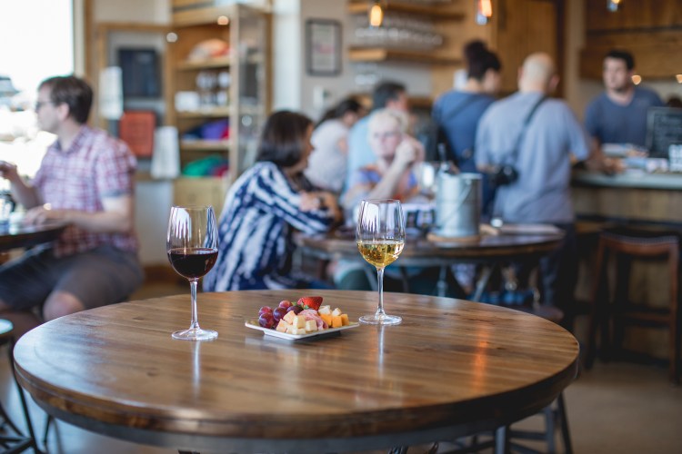 Wine glasses on a table with a cheese plate