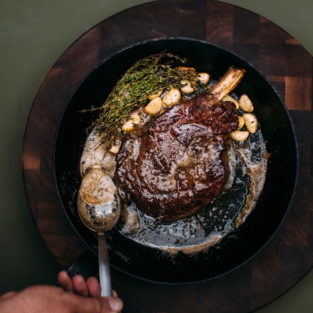 Steak in a cast iron pan with sauce