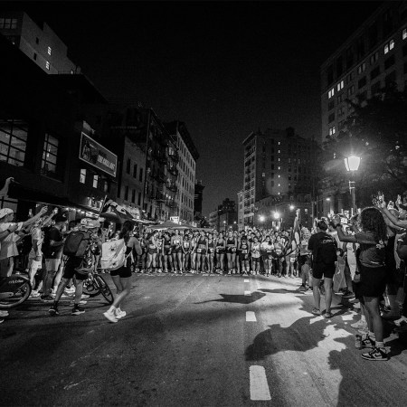 A group of runners lined up at the start of a Take The Bridge race in New York City. Here's the story behind Darcy Budworth's unsanctioned racing series.