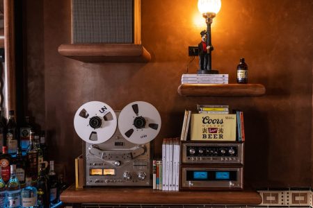 antique lamp with man on it, speakers, radios, drinks, books