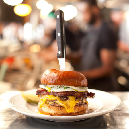 burger with knife stabbing through the middle