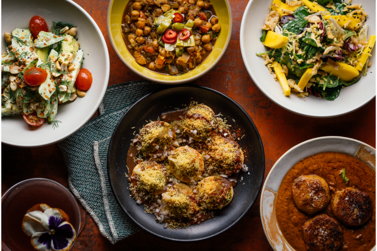 A spread of vegan food from Besharam in San Francisco, one of the best restaurants for vegans in the city