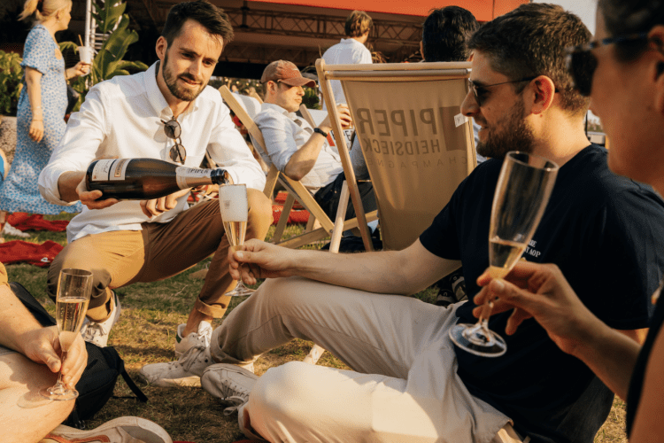 man pouring champagne into another man's glass