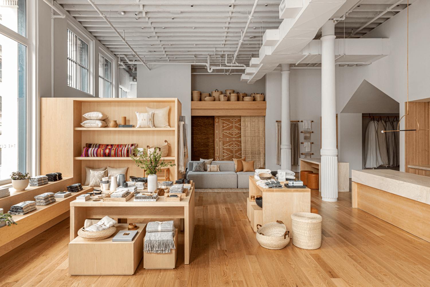 wooden shelves, pillows, pottery, blankets, plants, books